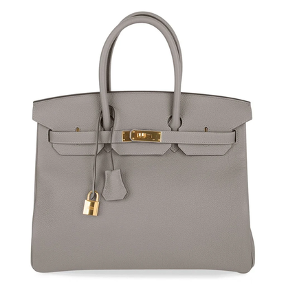 Calm Asphalt Grey Gentle Pebbled Grain Spacious Structured Hand Tote With Seamless Fine Stitching, Polished Golden Twist Lock Hardware And Matching Suspended Textured Tag Striped Metal Padlock Charm