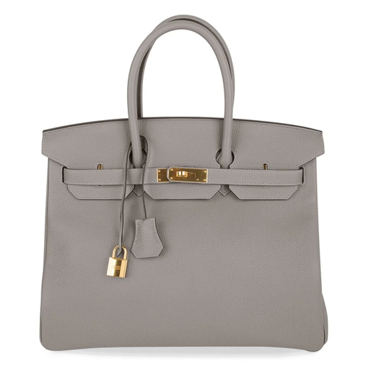 Calm Asphalt Grey Gentle Pebbled Grain Spacious Structured Hand Tote With Seamless Fine Stitching, Polished Golden Twist Lock Hardware And Matching Suspended Textured Tag Striped Metal Padlock Charm