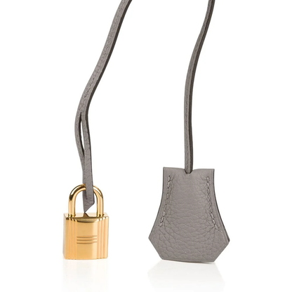Calm Asphalt Grey Gentle Pebbled Grain Spacious Structured Hand Tote With Seamless Fine Stitching, Polished Golden Twist Lock Hardware And Matching Suspended Textured Tag Striped Metal Padlock Charm