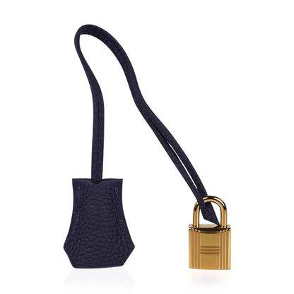 Saturated Midnight Navy Soft Subtle Pebbled Grain Roomy Structured Hand Tote With Seamless Uniform Stitching, Polished Golden Twist Lock Hardware And Matching Suspended Textured Tag Striped Metal Padlock Charm