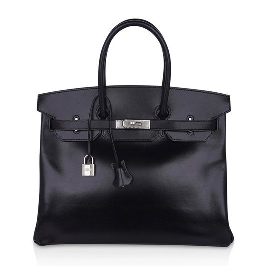 Sleek Jet Black Mirror-Sheen Polished Roomy Structured Hand Tote With Fine Tight Edge Stitching, Intricately Engraved Silvery Twist Lock Hardware And Matching Glossy Tag Etched Striped Metal Padlock Charm