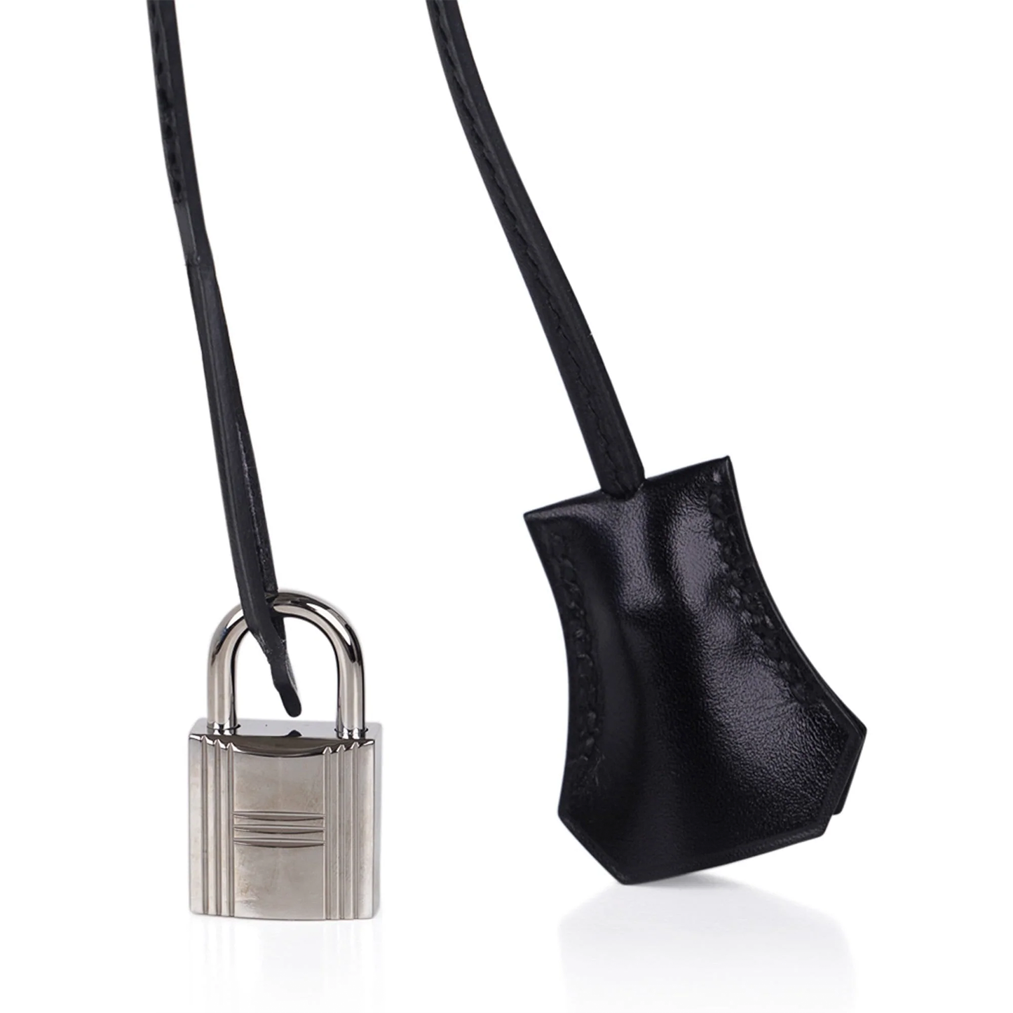 Sleek Jet Black Mirror-Sheen Polished Roomy Structured Hand Tote With Fine Tight Edge Stitching, Intricately Engraved Silvery Twist Lock Hardware And Matching Glossy Tag Etched Striped Metal Padlock Charm